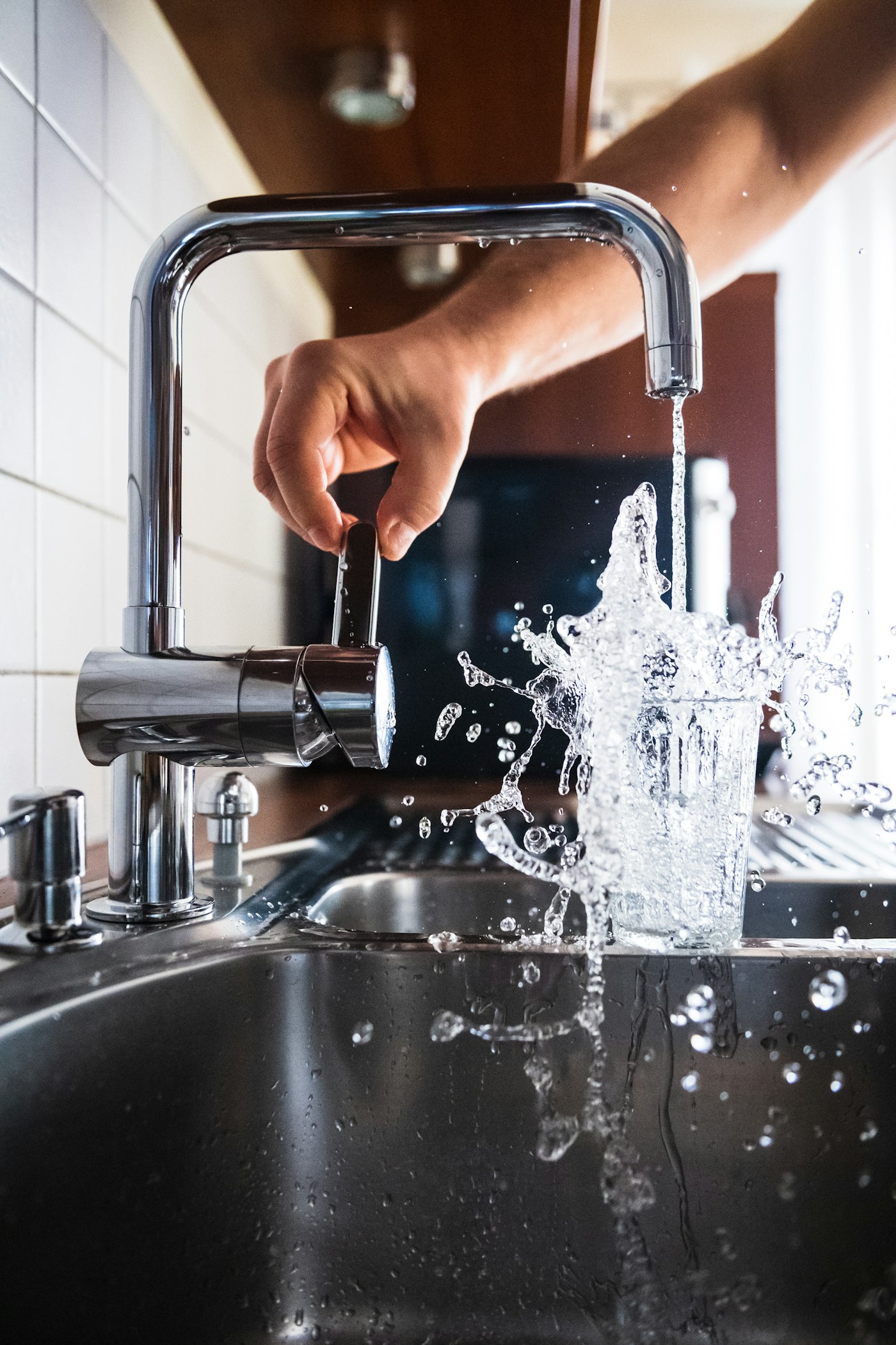 Faucet with water running in a kitchen sink
